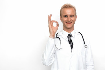 Doctor with stethoscope show off OK or all right sign by his hand on the white background. Medical and Healthcare concept. Hospital theme