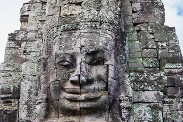 Fototapeta na wymiar Stone head on towers of Bayon temple in Angkor Thom, Cambodia