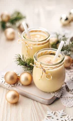 Rolgordijnen Eggnog alcoholic beverage served with cinnamon or nutmeg a traditional drink often served during Christmas © zi3000