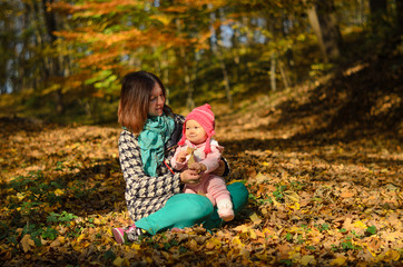 Happy family: mother and child little daughter in nature outdoors