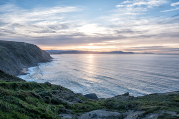 sea cave framing a beautiful beach at sunrise