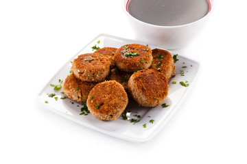 Meatballs with beet soup on white background