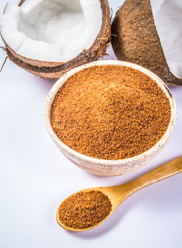 Coconut with coconut sugar isolated on white background.