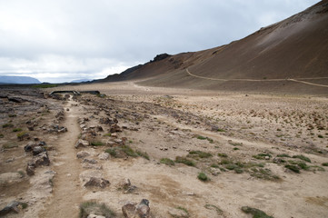Hverarönd, Iceland. Hot vapors in a typical Icelandic landscape, a wild nature of rocks and shrubs, rivers and lakes.