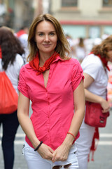 Woman in celebrating San Fermin festival in traditional white abd red clothing with red necktie, 08...