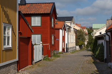 Fototapeta na wymiar Street in the old part of Vasteras town with traditional wooden houses, Sweden