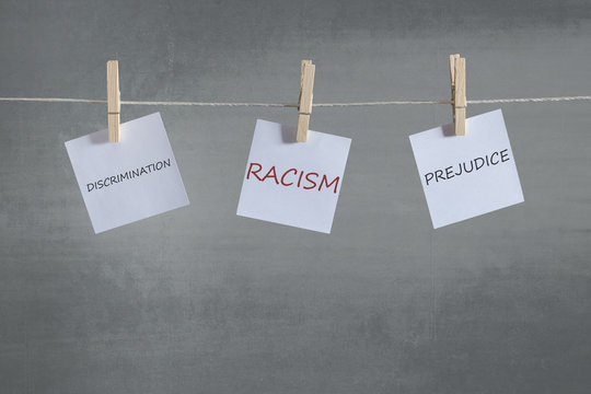Racism, prejudice and discrimination words on notes hanging on a clothesline. Social issues concept
