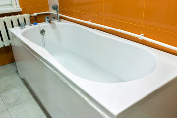 large white bath in the bathroom, interior of the house