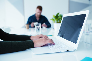 Girl works on a laptop. Concept of internet sharing and interconnection