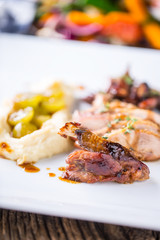 Pheasant breast and thigh roasted with mashed potatoes and grill vegetable. Delicious portion pheasant on plate in hotel or restaurant