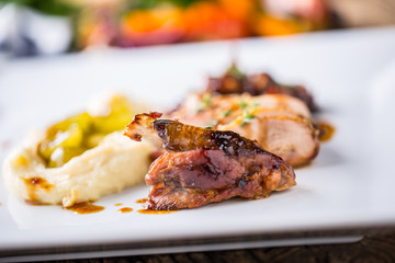 Pheasant breast and thigh roasted with mashed potatoes and grill vegetable. Delicious portion pheasant on plate in hotel or restaurant
