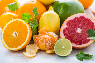 Fototapeta na wymiar Citrus fresh fruit. Orange grapefruit lemon lime with mint leaves