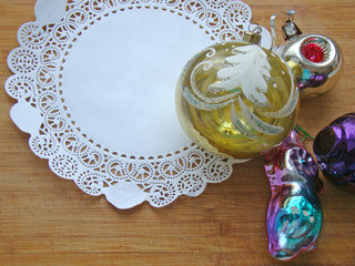 New Year's toys and white napkin on a wooden background