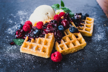 Waffles with ice cream and hot fruits sauce