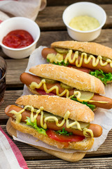 Fototapeta premium Hot dog in a bun with mustard and vegetables