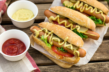 Hot dog in a bun with mustard and vegetables