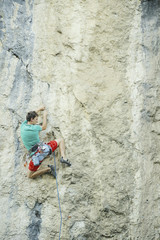 Fototapeta premium The climber climbs the rock.