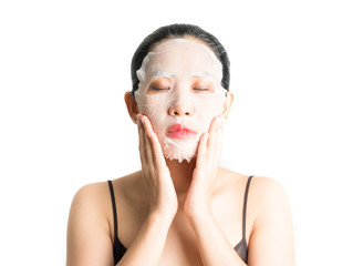 Young woman doing facial mask sheet with purifying mask on her face on white background