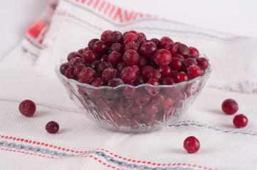 frozen cranberry berries in a plate on a white tablecloth