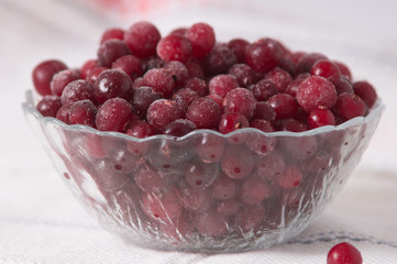 frozen cranberry berries in a plate on a white tablecloth