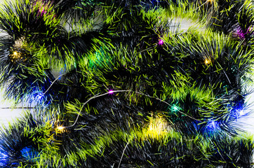 New Year's background of green ornaments and garland.