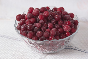 frozen cranberry berries in a plate on a white tablecloth