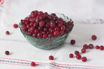 frozen cranberry berries in a plate on a white tablecloth