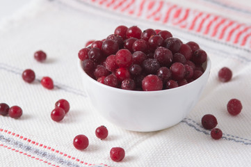frozen cranberry berries in a plate on a white tablecloth