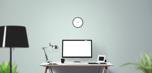 Computer display and office tools on desk.