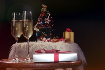 Christmas or New Year Celebration people hands with crystal glasses full of champagne near the Christmas tree and space for your text.
