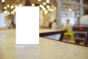 Mock up Menu frame standing on wood table in Bar restaurant cafe. space for text.