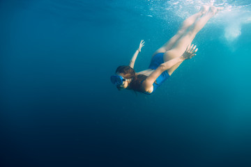 Obraz na płótnie Canvas Young woman swimming in ocean, snorkeling underwater view