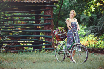 A healthy woman. Beauty Summer model girl with bright colors bicycle forest and basket. style leisure. A beautiful lady with an apple in her hand. Natural nature. Cosmetic makeup fashion