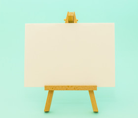 +White paper on little easel on colorful background