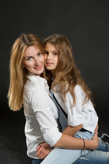 Mom and daughter hugging,  family same look, fashion style