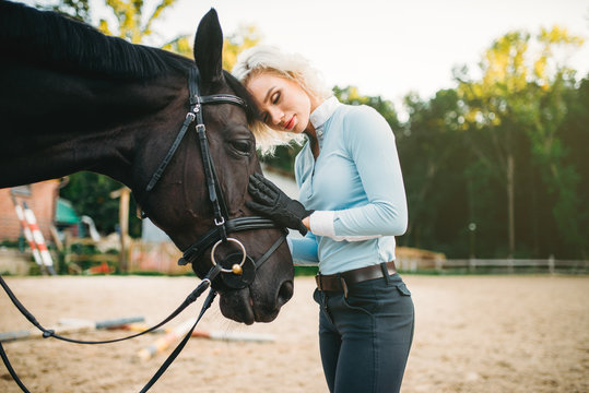 Woman hugs her horse, friendship, horseback riding