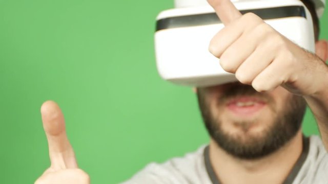 happy man using VR Glasses on green background, close up, isolate