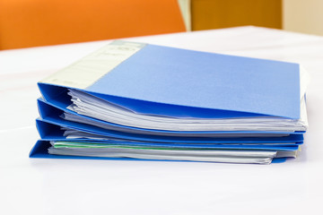 blue files folder. retention of contracts and paper. on the table in the meeting room 