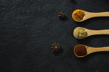 Star anise with various spices powder in wooden spoon