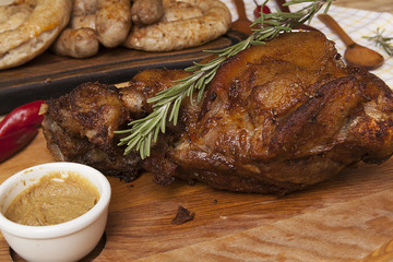 pork knuckle on the kitchen wooden table, hot meat dish
