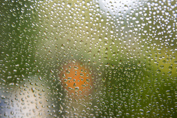 Water droplets on the window. Blurry background.