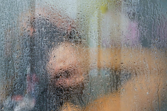 Woman Washing Behind Weeping Glass Shower Door