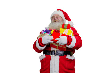 Portrait of Santa Claus with Christmas gifts. Happy Santa Claus holding a pile of gift boxes, isolated on white background. Santa Claus carrying presents to children.