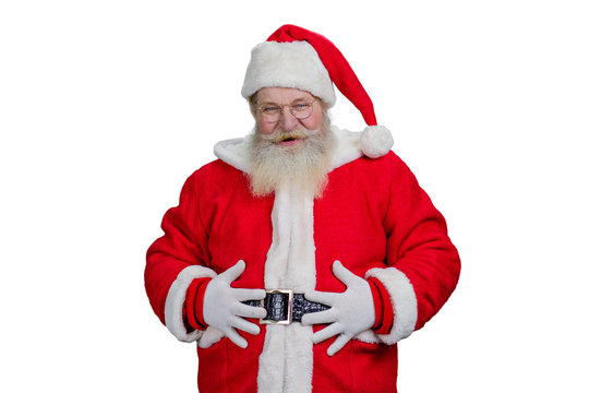 Old Santa with hands on belly. Portrait of realistic Santa Claus holding hands on belly and looking at camera. Authentic Santa Claus, studio shot.