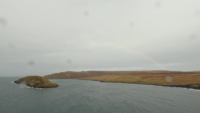 Rainbow over sea landscape of the Isle of Skye in Scotland - view from ruins of Macleod castle