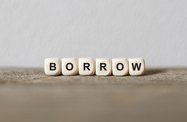 Word BORROW made with wood building blocks