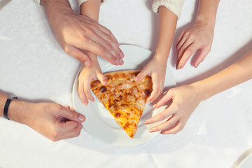 People Hands Grabbing Pizza from white plate