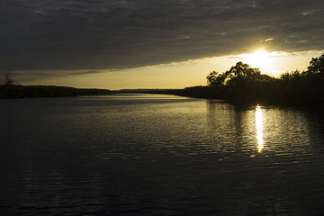 Fototapeta na wymiar Beautiful sunset over the river.Travels. Fishing