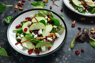 Homemade Autumn Apple Cranberry Salad with walnut, feta cheese and vegetables