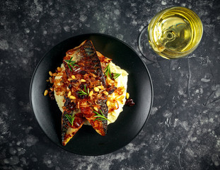 Sicilian style mackerel on cauliflower puree with caramelized onions, pine nuts served white wine